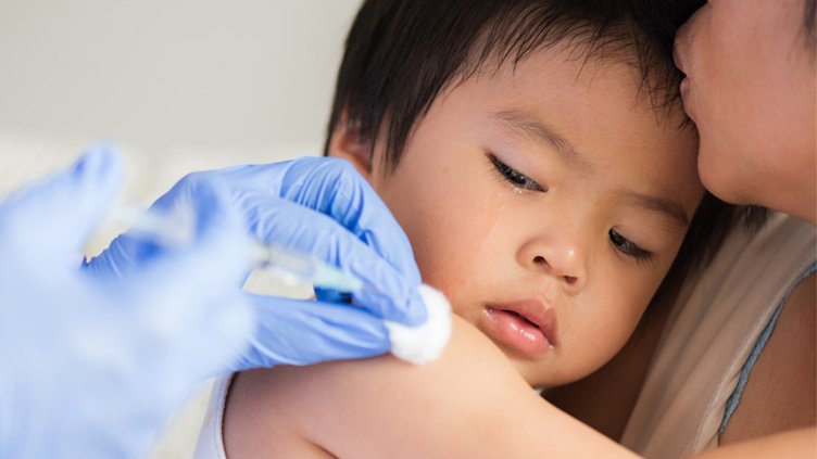 Child receives a vaccine shot